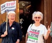 Frankie and friend with placards on 2014 protest in london against Israel's attack on Gaza. 'UK stop arming Israel.